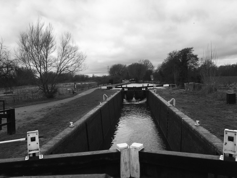 Black and white photo looking over the look and up the canal.